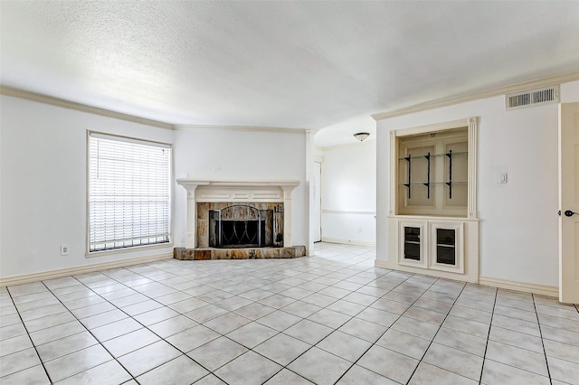 unfurnished living room featuring light tile patterned floors, baseboards, visible vents, a textured ceiling, and a fireplace