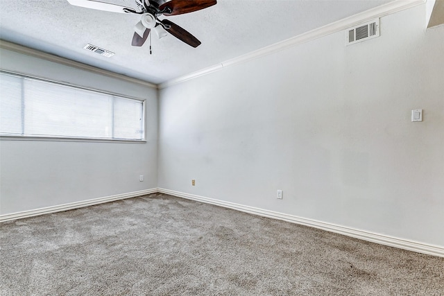 unfurnished room featuring visible vents, ceiling fan, ornamental molding, a textured ceiling, and carpet floors