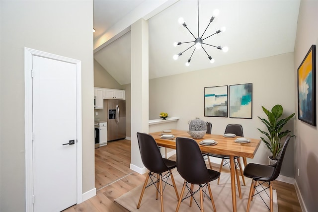 dining area with baseboards, an inviting chandelier, lofted ceiling, and light wood-style floors