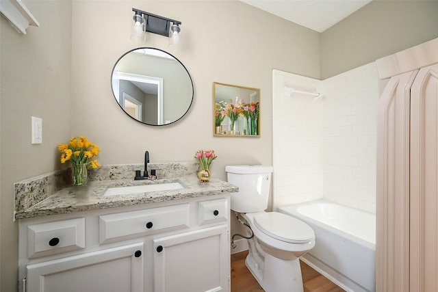 full bath featuring toilet, shower / bath combination, wood finished floors, and vanity