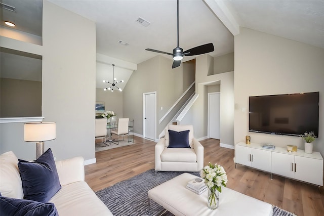 living room with light wood-style floors, visible vents, and baseboards