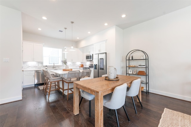 dining area featuring dark wood-type flooring, recessed lighting, and baseboards