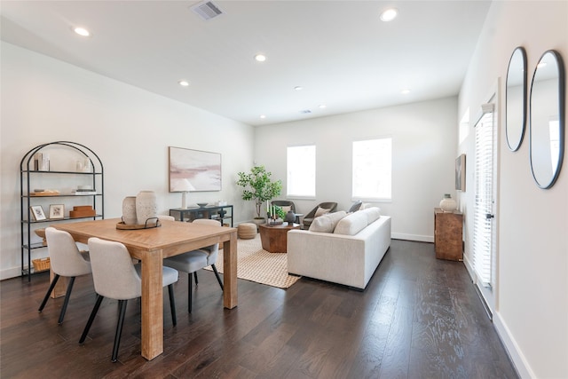 dining room featuring dark wood-type flooring, recessed lighting, visible vents, and baseboards