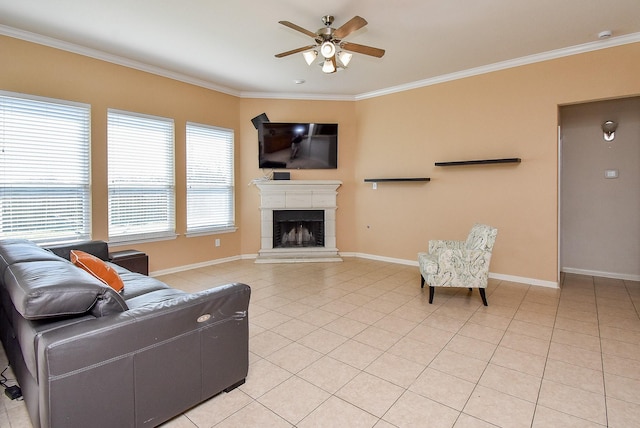 living room with light tile patterned floors, ornamental molding, a tile fireplace, and baseboards