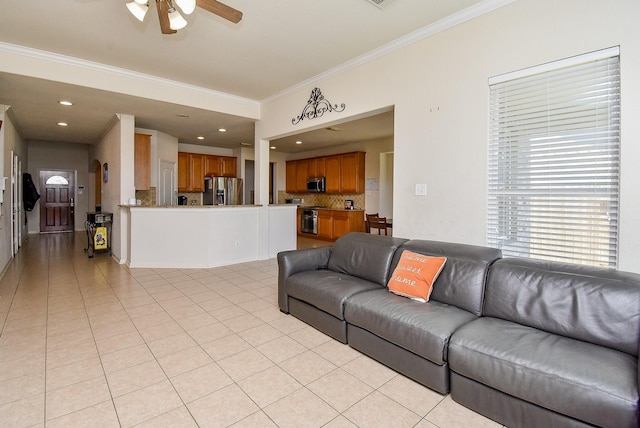 living room featuring a ceiling fan, recessed lighting, crown molding, and light tile patterned floors