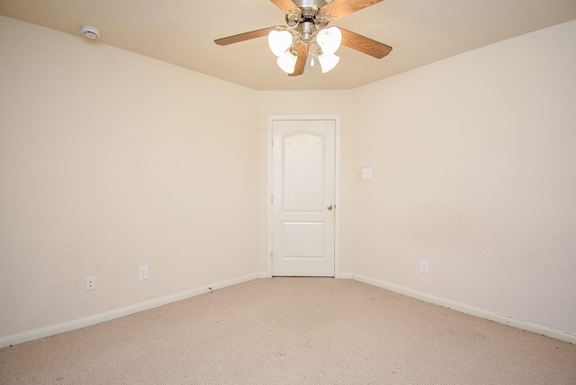 unfurnished room with a ceiling fan, light colored carpet, and baseboards