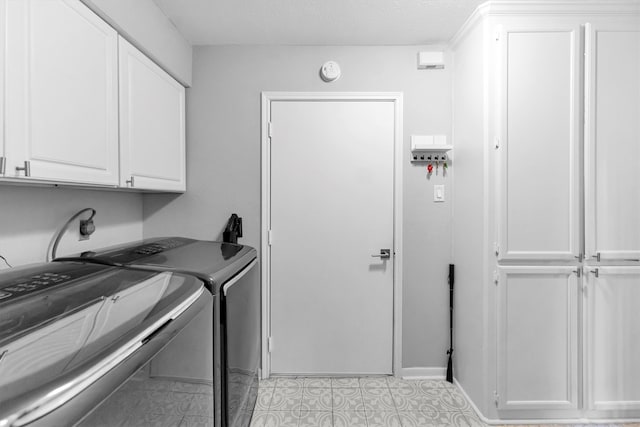 laundry area featuring cabinet space and separate washer and dryer