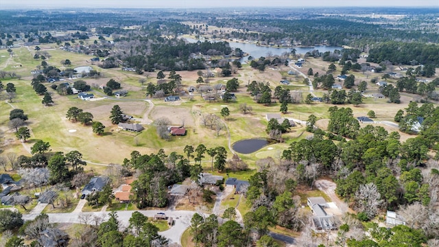 birds eye view of property with a water view and golf course view