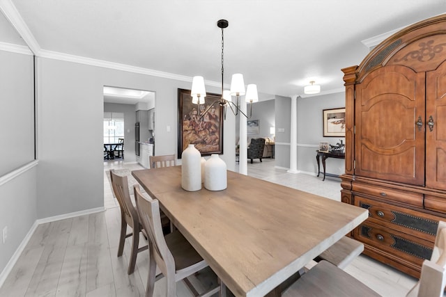 dining space with a chandelier, crown molding, baseboards, and decorative columns