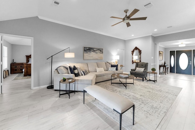 living area featuring a ceiling fan, lofted ceiling, visible vents, and baseboards