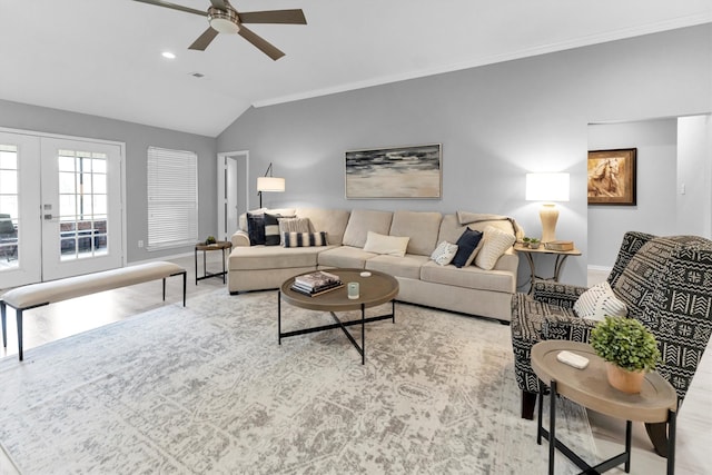 living room featuring a ceiling fan, baseboards, vaulted ceiling, french doors, and ornamental molding