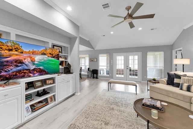 living room with lofted ceiling, french doors, visible vents, and light wood-style flooring