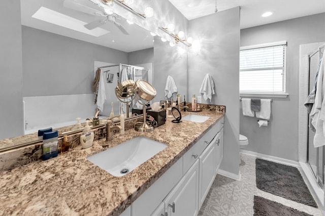 bathroom featuring double vanity, a stall shower, and a sink