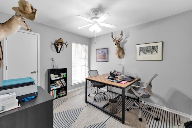 office with a ceiling fan and baseboards