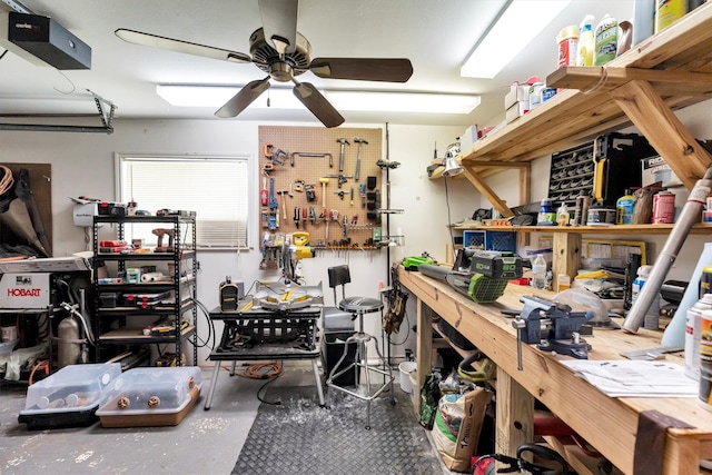 interior space featuring a workshop area, a ceiling fan, and a garage door opener