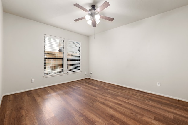 unfurnished room featuring baseboards and wood finished floors