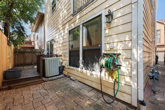 view of patio with fence and central air condition unit