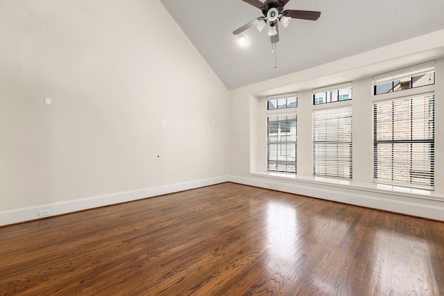 spare room featuring ceiling fan, vaulted ceiling, baseboards, and wood finished floors