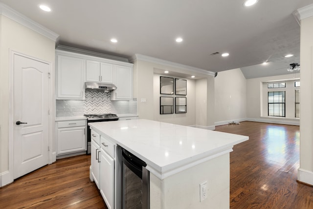 kitchen featuring wine cooler, stainless steel range with gas cooktop, white cabinets, and under cabinet range hood