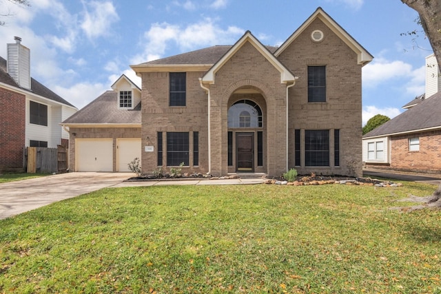 traditional-style home featuring driveway, an attached garage, fence, a front lawn, and brick siding