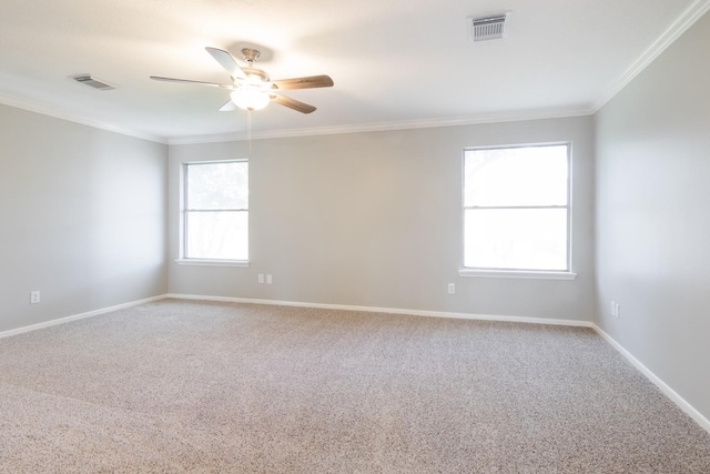 unfurnished room with baseboards, ceiling fan, visible vents, and crown molding