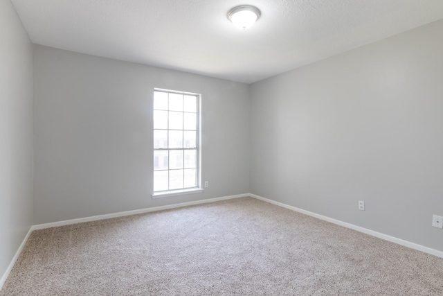 empty room with carpet flooring and baseboards