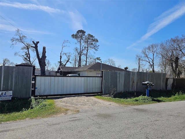 view of gate with a fenced front yard