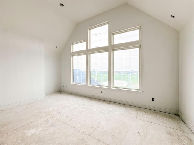 bonus room with vaulted ceiling and baseboards