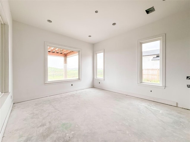 empty room featuring baseboards and unfinished concrete floors