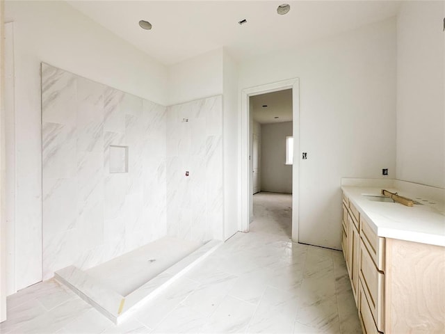 full bathroom featuring a stall shower, marble finish floor, and vanity