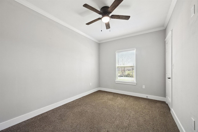 empty room featuring a ceiling fan, baseboards, dark carpet, and crown molding