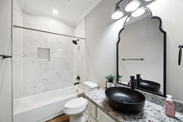 full bathroom featuring a textured wall, toilet, ornamental molding, washtub / shower combination, and vanity