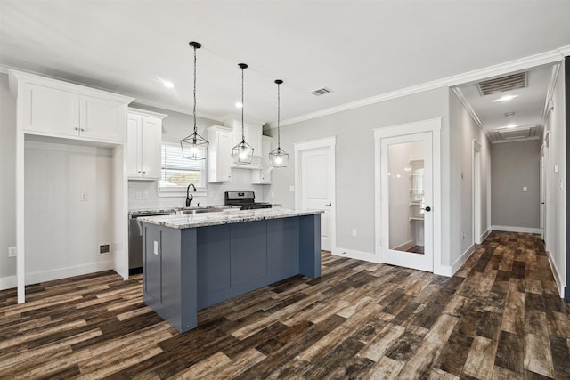 kitchen with white cabinetry, visible vents, appliances with stainless steel finishes, and tasteful backsplash