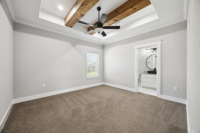 carpeted spare room featuring baseboards, crown molding, a tray ceiling, and a ceiling fan