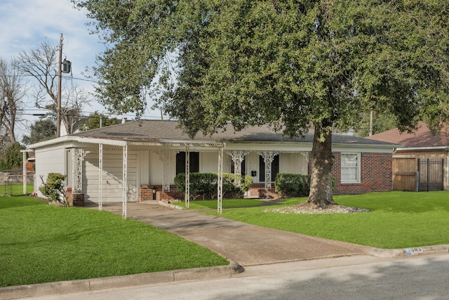 single story home with concrete driveway, brick siding, a front yard, and fence