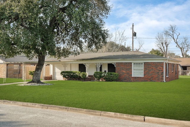 single story home featuring a front lawn, brick siding, and an attached garage