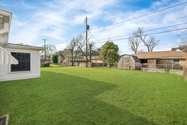 view of yard featuring a fenced backyard, a storage unit, and an outbuilding