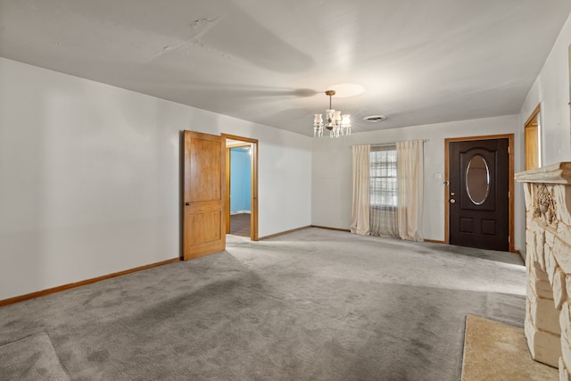 interior space featuring carpet floors, a notable chandelier, and baseboards