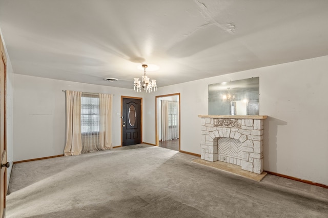 unfurnished living room with an inviting chandelier, carpet, baseboards, and a stone fireplace