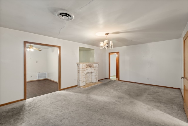 unfurnished living room with carpet, visible vents, and a stone fireplace