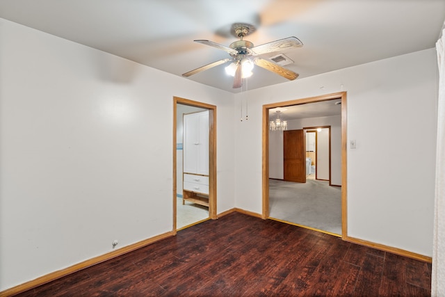 unfurnished room featuring visible vents, wood finished floors, a ceiling fan, and baseboards