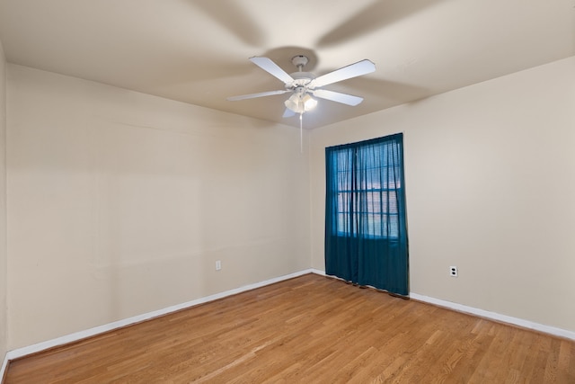 empty room with light wood-type flooring, baseboards, and a ceiling fan