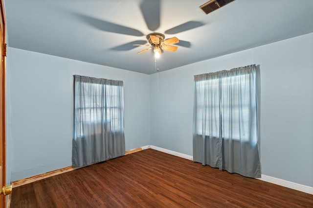 unfurnished room featuring visible vents, ceiling fan, baseboards, and wood finished floors