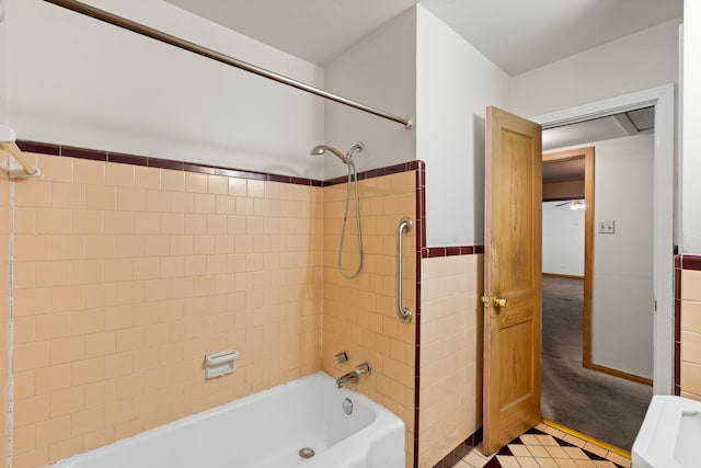 bathroom with shower / bathing tub combination, tile walls, and tile patterned floors