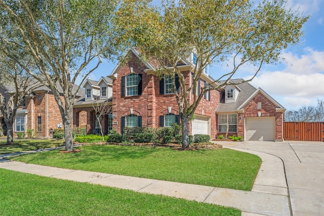 view of front facade with a garage, brick siding, concrete driveway, fence, and a front yard