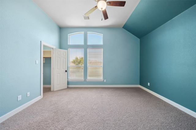 2405 Pebble Lodge Ln, Friendswood, TX 77546 - unfurnished bedroom featuring carpet floors, baseboards, lofted ceiling, a walk in closet, and a ceiling fan