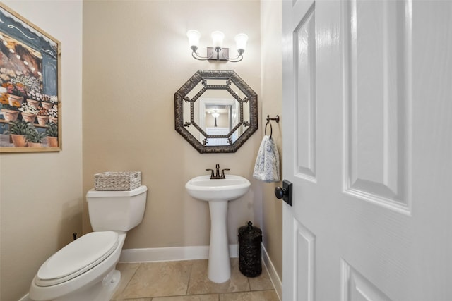 bathroom featuring toilet, baseboards, and tile patterned floors