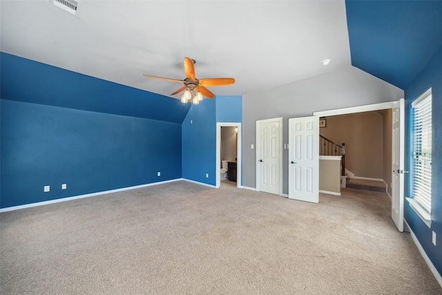 unfurnished bedroom featuring lofted ceiling, baseboards, visible vents, and carpet flooring