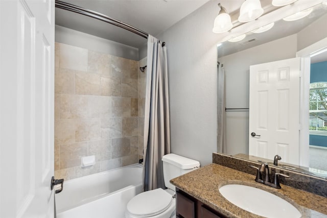 full bathroom featuring visible vents, a textured wall, toilet, shower / bath combo with shower curtain, and vanity