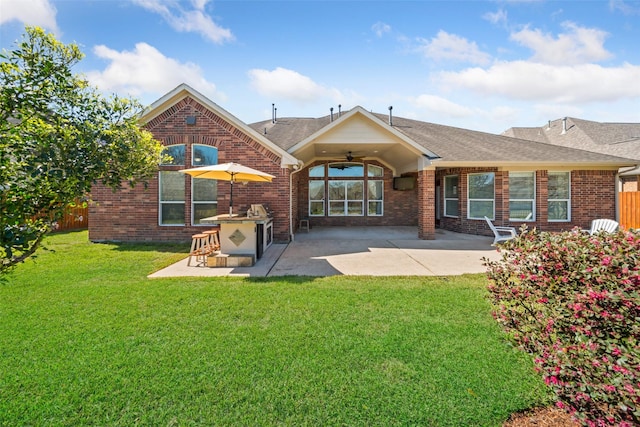 rear view of house with a ceiling fan, a patio area, brick siding, and fence